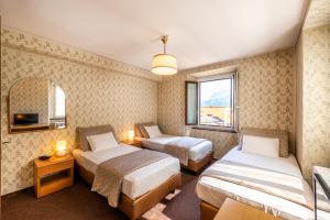Rúm í herbergi á Albergo Ristorante Svizzero