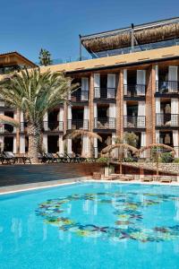 a large swimming pool in front of a hotel at Bikini Island & Mountain Port de Soller "Adults only" in Port de Soller