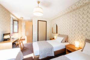Rúm í herbergi á Albergo Ristorante Svizzero