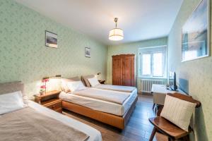 Postel nebo postele na pokoji v ubytování Albergo Ristorante Svizzero