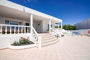 a white house with stairs and a swimming pool at Villa Mariemne VIP in Playa Honda