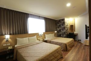 Postel nebo postele na pokoji v ubytování Monalisa Hotel