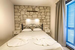 Postel nebo postele na pokoji v ubytování Bademli Konak Otel