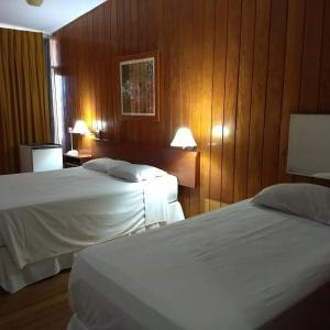 A bed or beds in a room at Hotel Tijuco Turismo