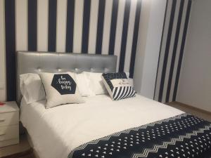 Łóżko lub łóżka w pokoju w obiekcie Portosín -Suites