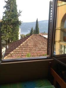 a window with a view of a roof at Sobe Baosici Marina in Herceg-Novi +16 photos