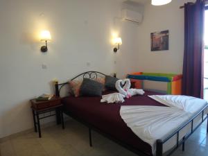 Posteľ alebo postele v izbe v ubytovaní Amfi Apartments