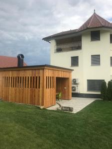 a backyard with a wooden fence next to a house at Apartments & Wellness Skok in Mozirje