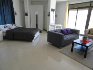 a living room with a bed and a couch at Diyarkom Apartment in Amman