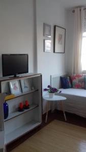 a living room with a couch and a tv at B&B Nerja in Nerja