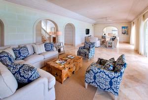 a living room with couches and chairs and a table at Howzat! by Island Villas in Saint James