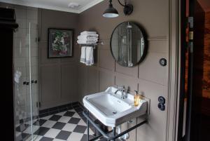 a bathroom with a sink and a mirror at Tweed Hotell Skaftö in Fiskebäckskil +43 photos