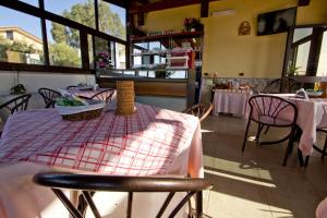 a dining room with a table with a table cloth on it at Villa Jolanda & Carmelo in Villaggio Mosè