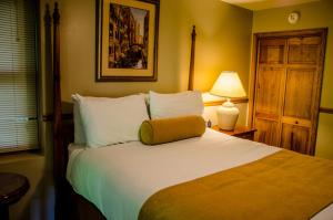 a bedroom with a large bed with a yellow pillow on it at Asheville Cabins of Willow Winds in Asheville