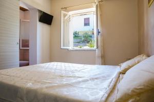 a bedroom with a large bed and a window at B&B del Sole Tropea in Tropea