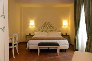Ένα ή περισσότερα κρεβάτια σε δωμάτιο στο Hotel Borgo Antico