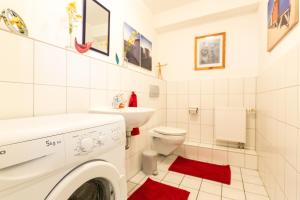 a white bathroom with a washing machine in it at Ferienwohnung Mittendrin in Bergisch Gladbach