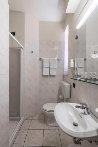 a bathroom with a sink and a toilet and a shower at Hotel Montebello in Montecatini Terme