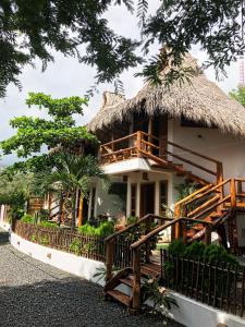 a resort building with a thatched roof at Casitas Pacific in Popoyo