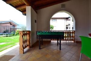 a room with a pool table on a patio at La Gallina in Artogne