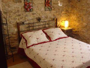 1 dormitorio con 1 cama en una pared de piedra en Casas Lucas - Carleo, en Outes
