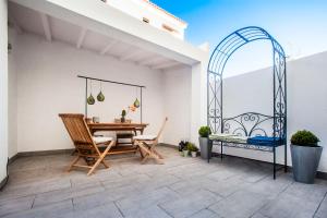 a patio with a table and chairs on a balcony at "Scandinavian" apartment in Cascais's old town in Cascais