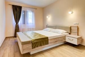 a bedroom with a large bed and a window at Apartments MarijaZ 2 in Kotor