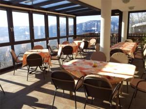 a restaurant with tables and chairs on a balcony at Gasthof Walde in Rifiano +28 photos