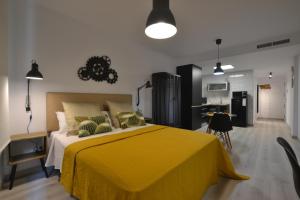 una camera con letto giallo e una cucina di Loft Urban Casual ad Alicante