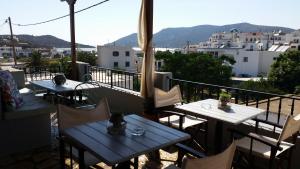 een patio met tafels en stoelen op een balkon bij Studio Katerina in Lipsoi