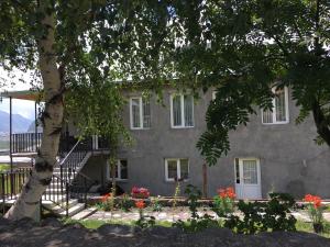a house with a staircase in front of it at Cherry in Stepantsminda