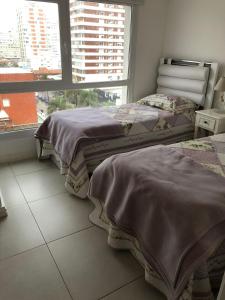 เตียงในห้องที่ Punta del Este Lux Tower