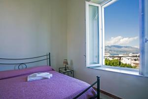 a bedroom with a bed and a large window at Bed and Breakfast La Torretta in Gaeta