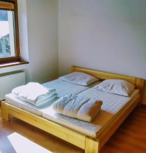 a bed with two pillows on it in a room at Apartman pod Kalváriou - rodinný dom in Banská Štiavnica