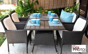 a wooden table and chairs with blue cups on it at Apartments Marcela in Stari Grad