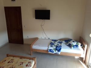a bedroom with a bed and a tv on the wall at Korac Apartments in Ulcinj