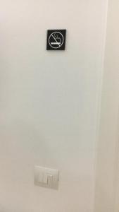 a black sign on a wall with a bicycle on it at Barnab@House in Monopoli