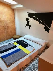a bedroom with a bed with a man hanging from an umbrella at Apartament Cala Magda Sant Llorenç de Montgai in Sant Llorenç de Montgai