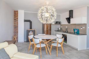 a kitchen and dining room with a table and chairs at Villa Koffi Apartments 16 plus in Puck