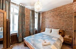 a bedroom with a brick wall and a bed at Apartament Starówka no1, no2, no3 in Toruń