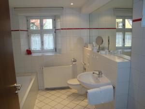 a white bathroom with a sink and a toilet at Hotel Haus Appelberg in Dinkelsbühl