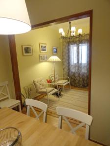 a dining room with a table and chairs and a living room at Oceanos in Costa da Caparica