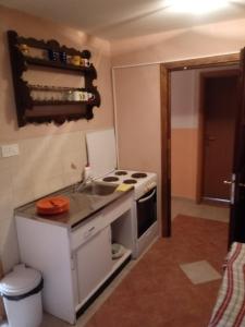 a small kitchen with a stove and a sink at Apartments Salute in Mostar