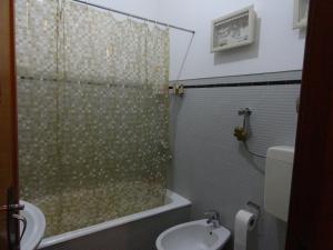 a bathroom with a shower and a toilet and a sink at Oceanos in Costa da Caparica +31 photos