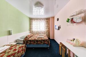 a hotel room with two beds and a window at Hotel AQUARELLE (East of Moscow) in Moscow