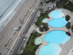 an overhead view of a beach with three swimming pools at Departamento La Serena in Coquimbo