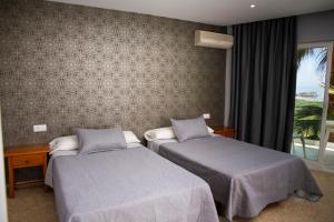 Łóżko lub łóżka w pokoju w obiekcie Hotel Salambina