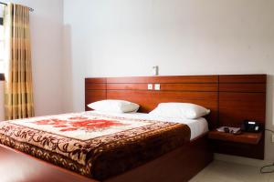 Postel nebo postele na pokoji v ubytování Hôtel Mirambeau