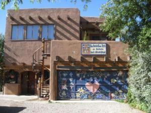 a building with a mural on the front of it at La Dona Luz Inn an Historic B&B in Taos