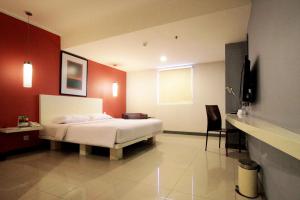 a bedroom with a white bed and red walls at Hotel Glodok Plaza in Jakarta +50 photos